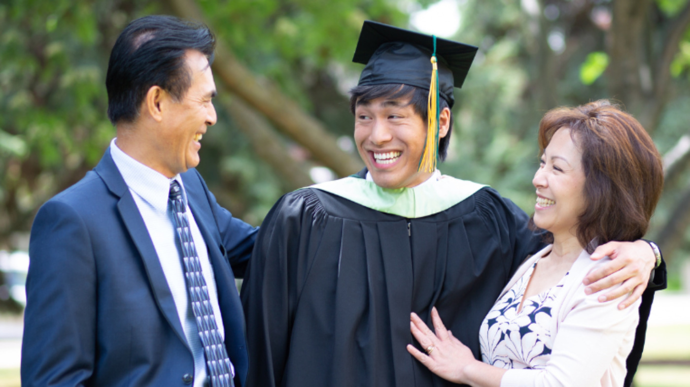 Parents congratulating their child upon graduation