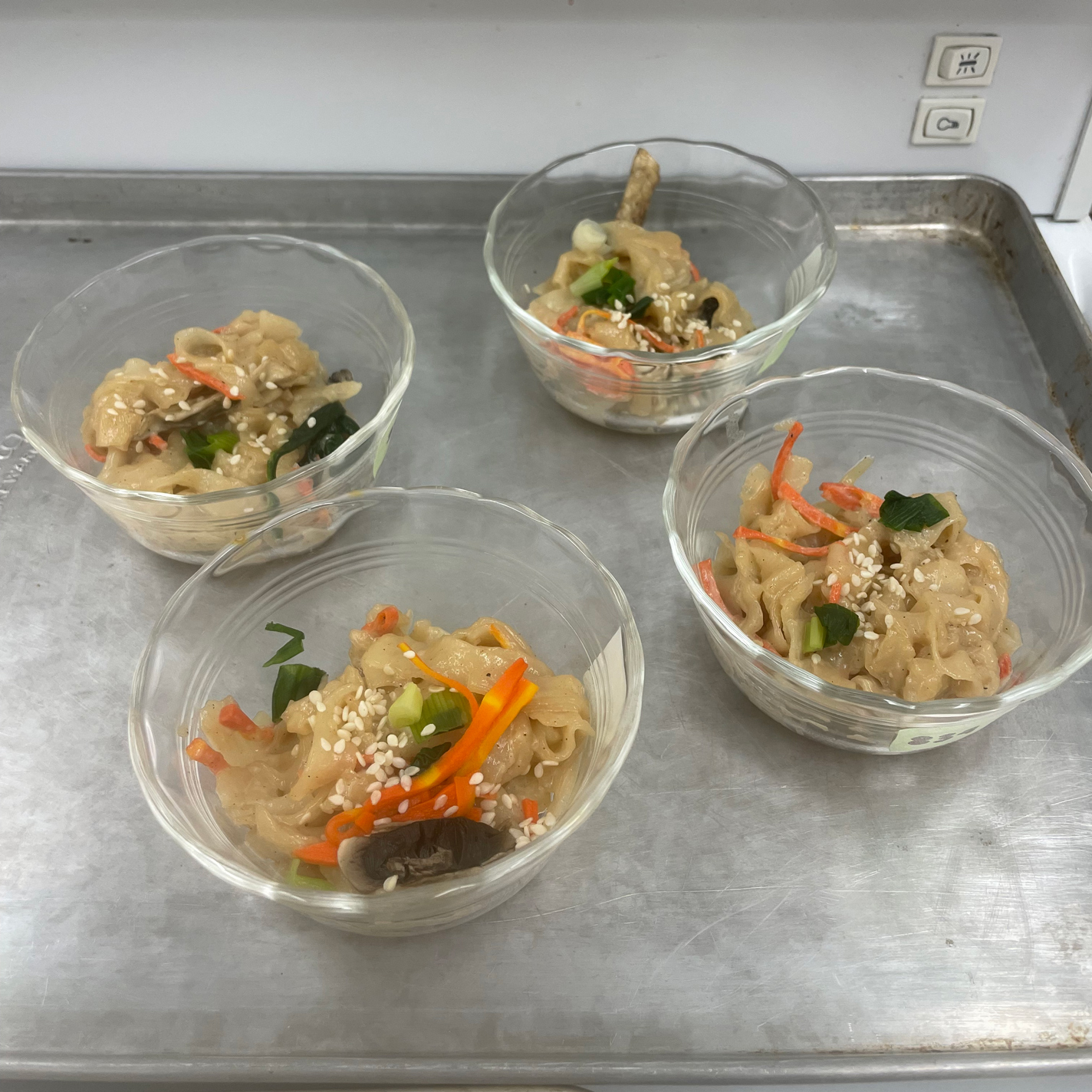 Picture of samples of Korean dish with noodles and vegetables