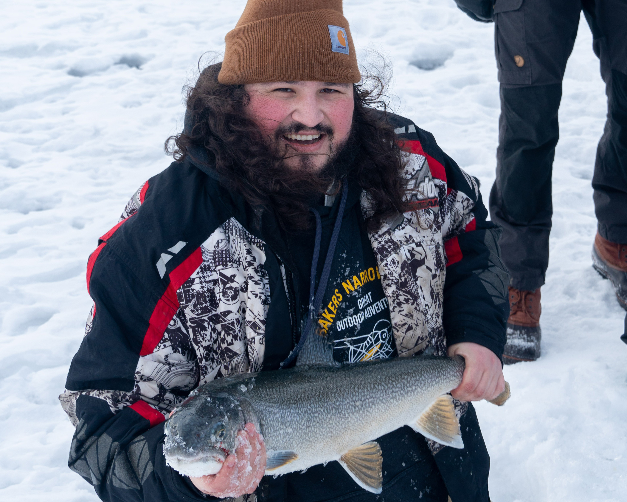 Photo of Remington holding a fish he caught ice fishing