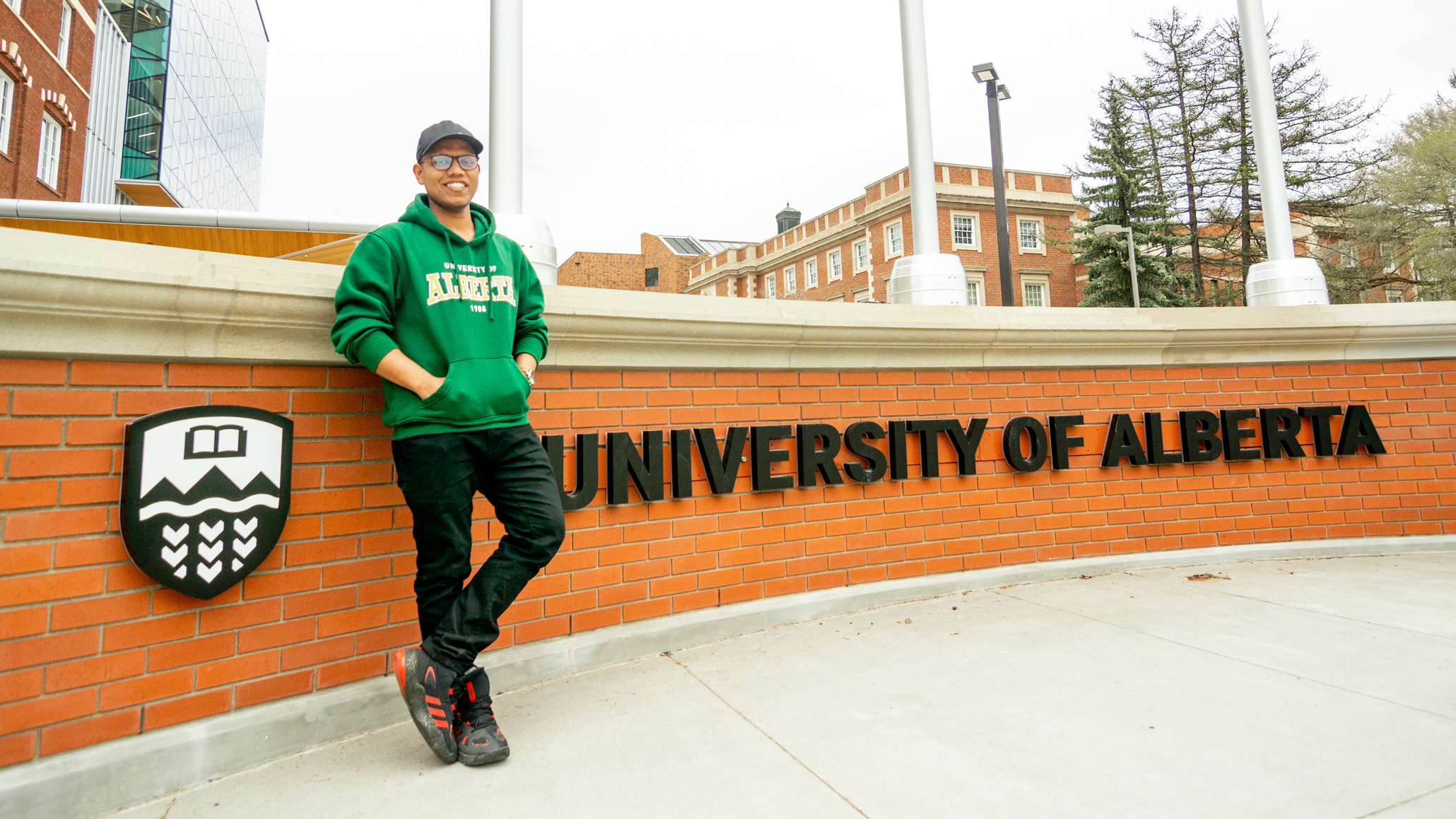 Saiful poses at the University of Alberta brick wall on North Campus