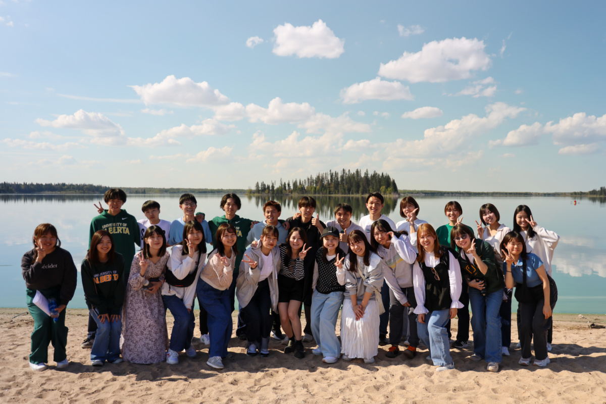 Large group of ELS students in front of the water at Elk Island park