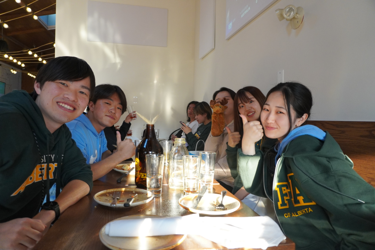 Group of students eating a meal at a restaurant