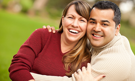 Happy female and male couple embracing