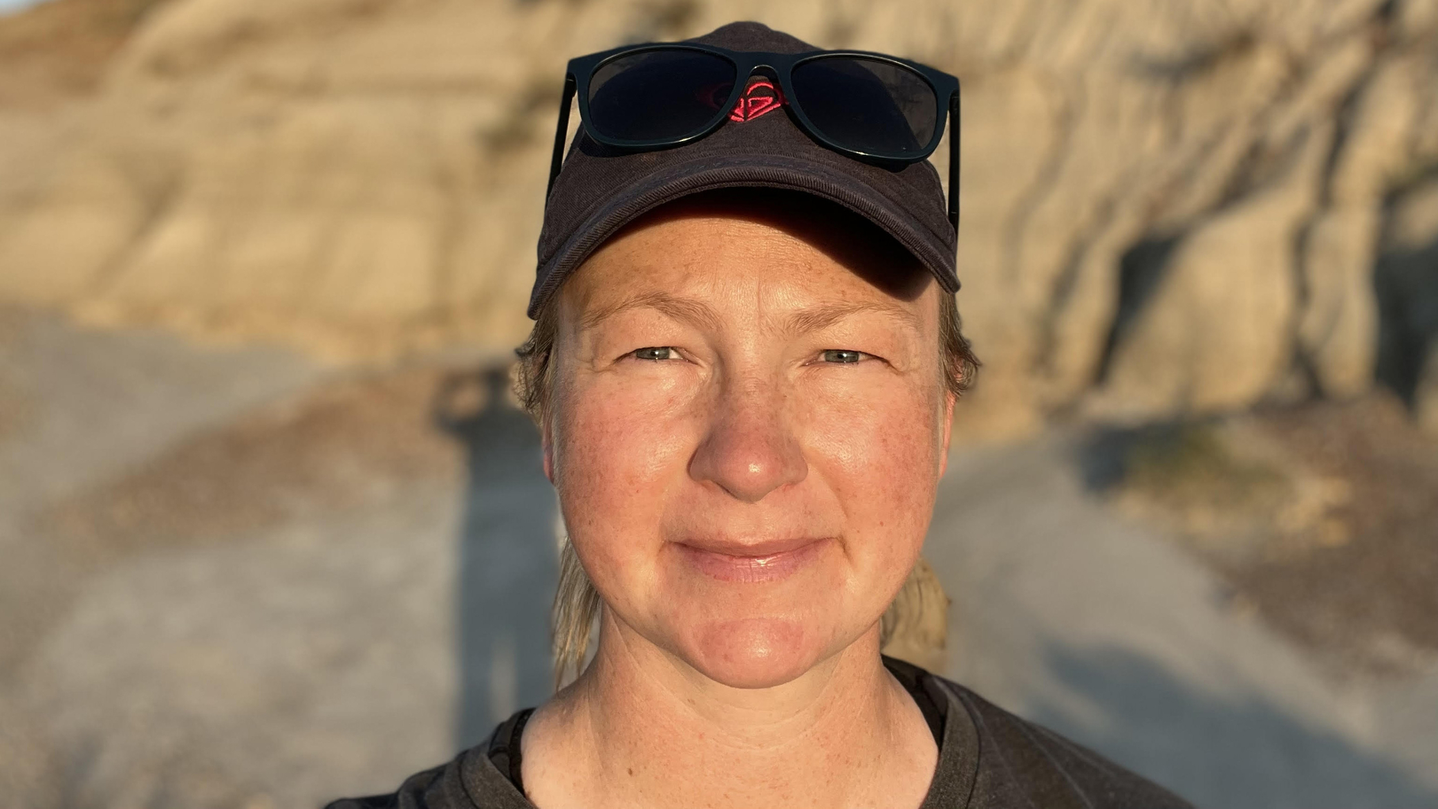 Headshot of Christina outside in a mountain landscape