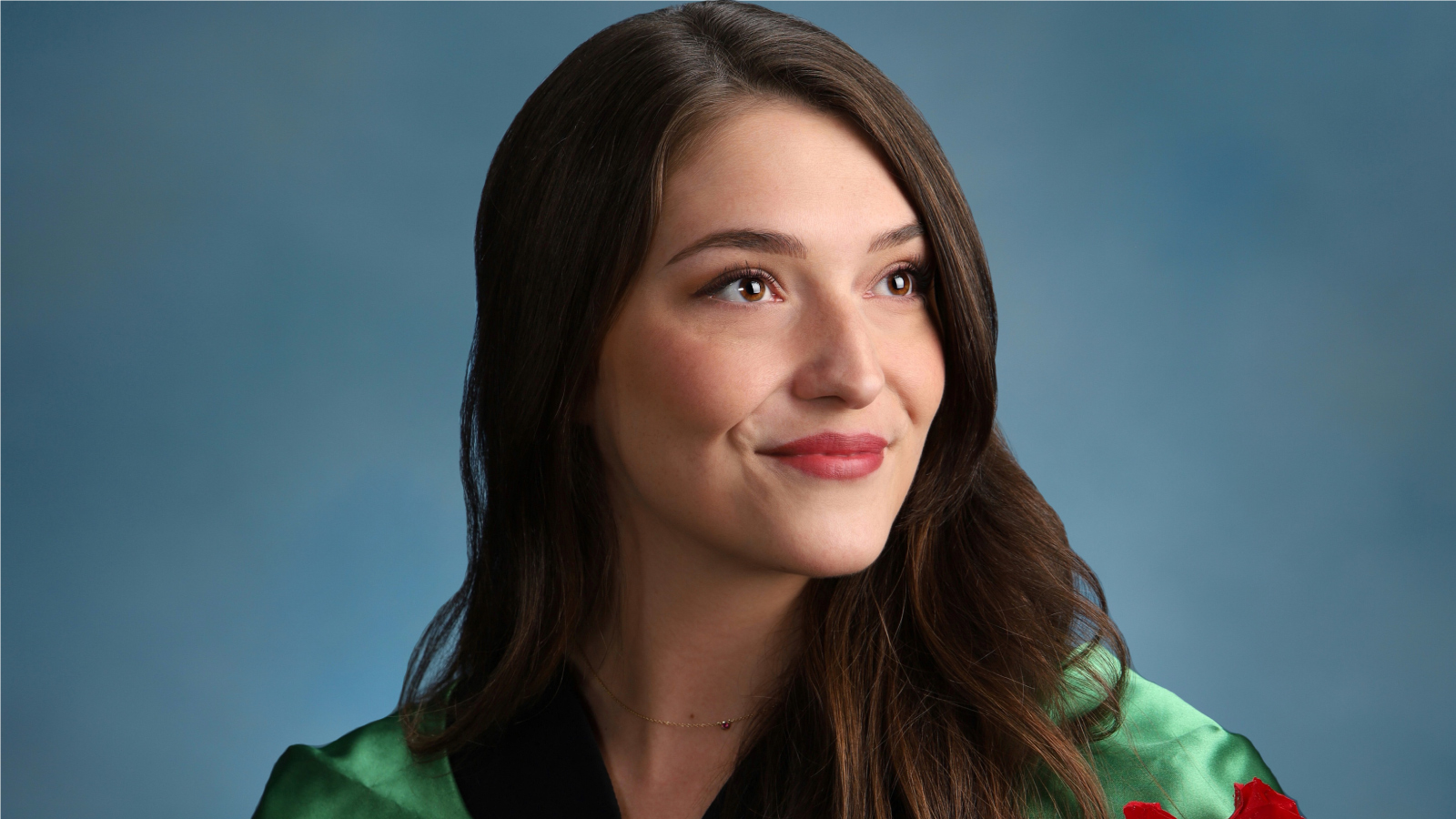 Portrait of Coral wearing cap and gown.