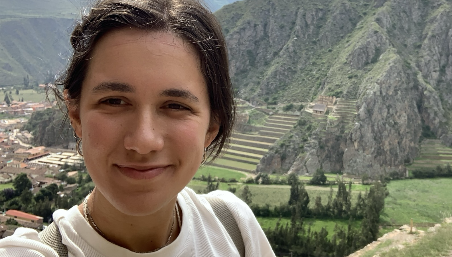 Student portrait in front of mountain artefacts.