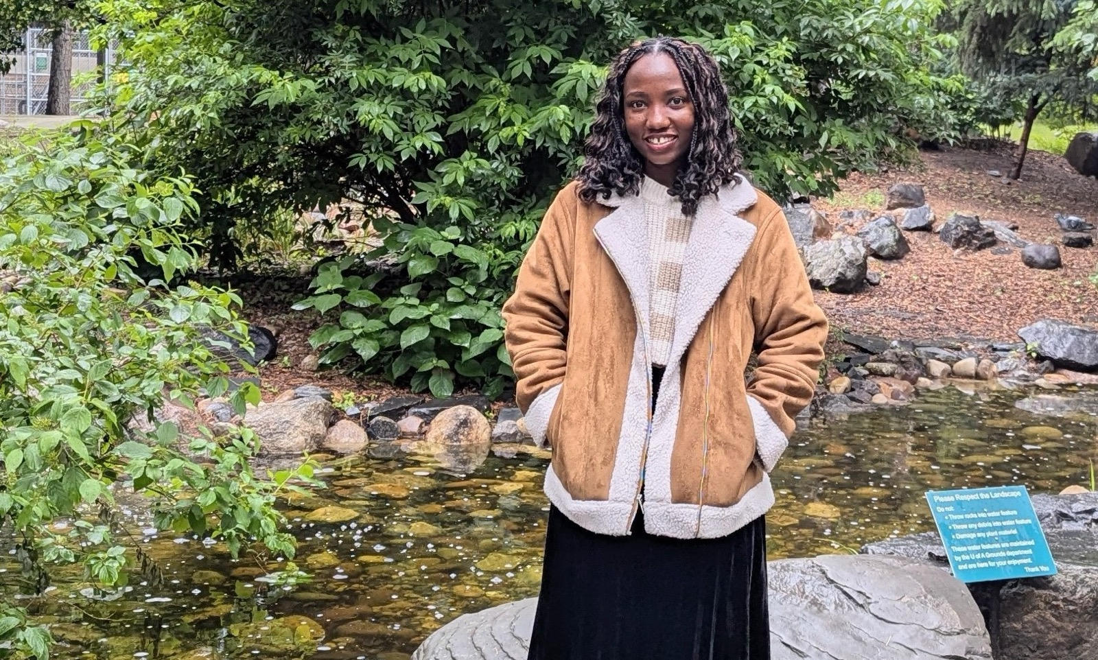 Student in front of a garden display