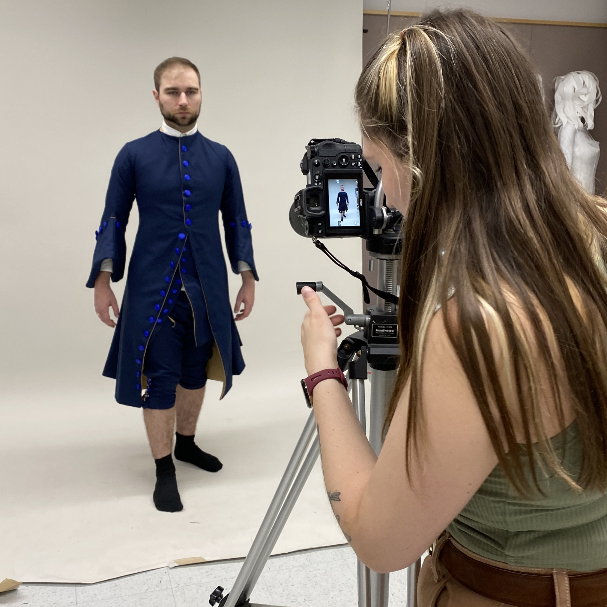 A young man is photographed dressed in historical garments