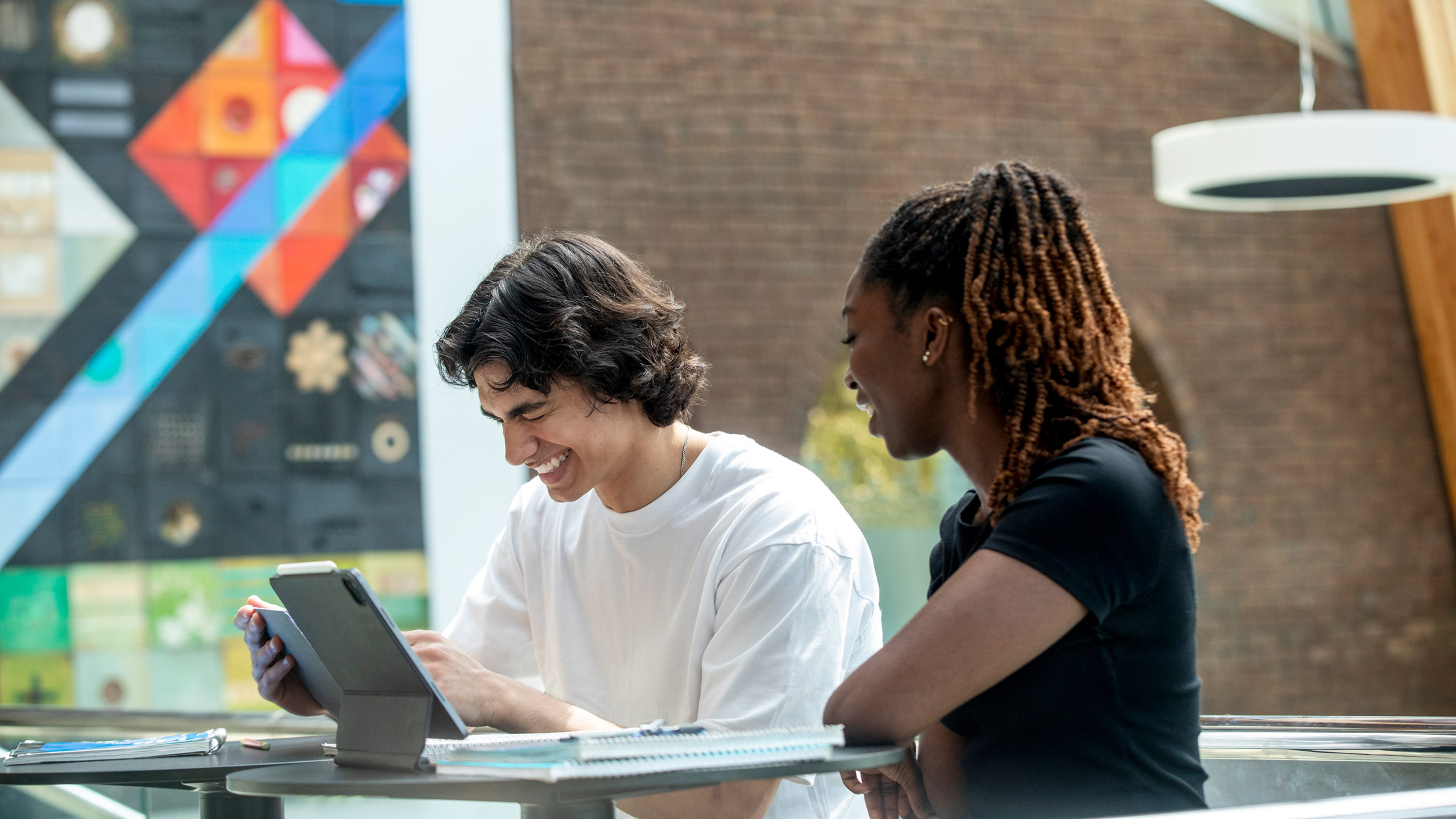 two students study in the ales atrium