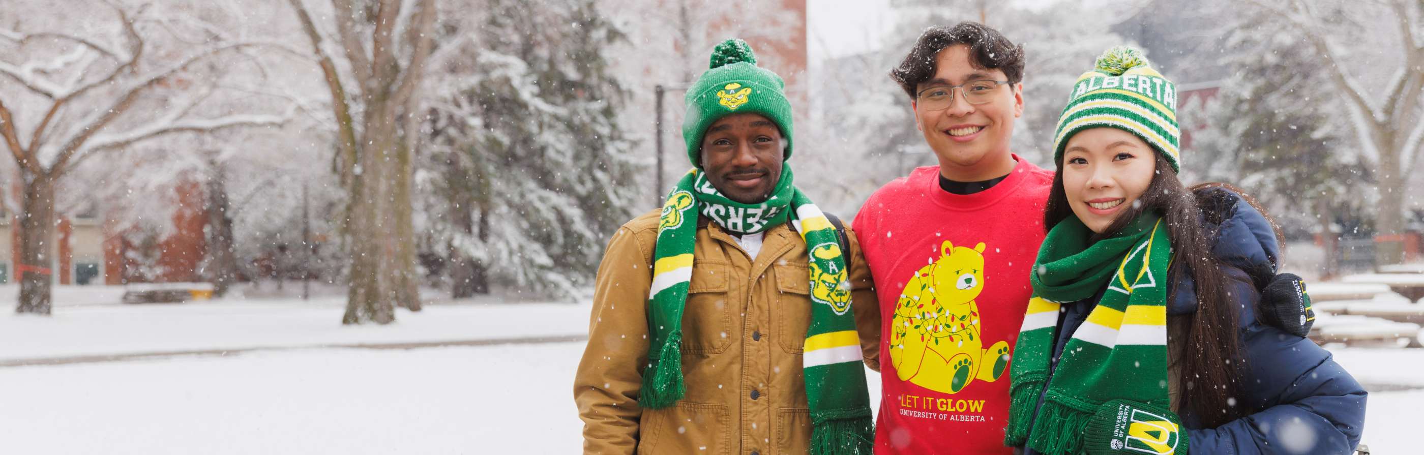 Three students wearing U of A winter gear