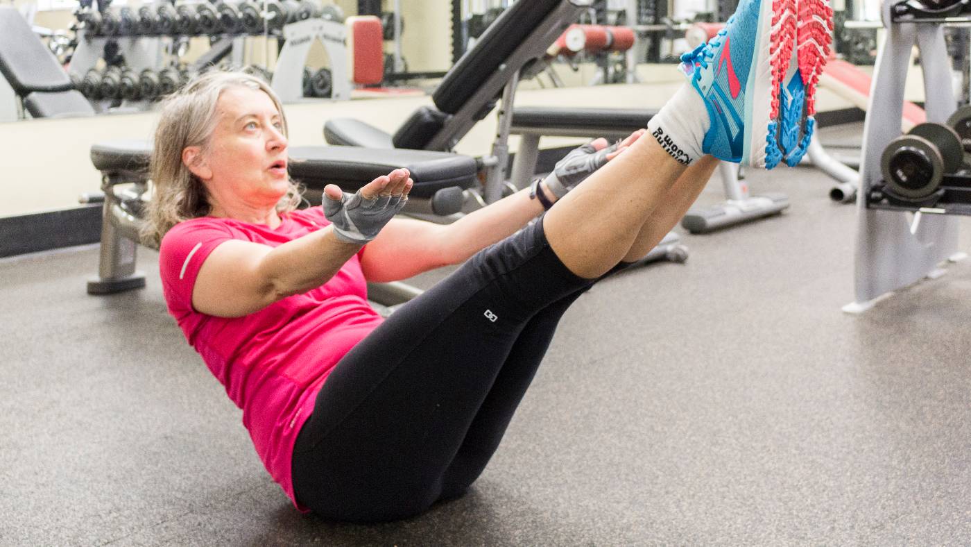 Womandoing a V sit exercise