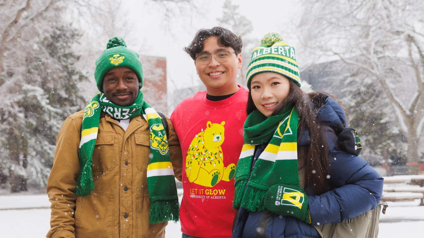 Three students wearing U of A winter gear