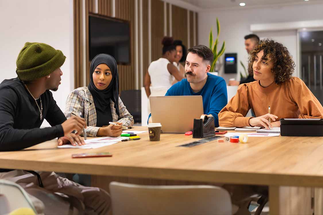 Group of people work around a table