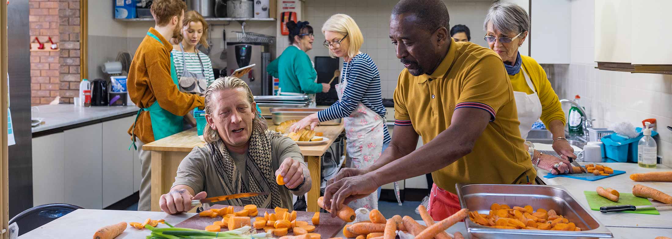 Volunteers work in a kitchen