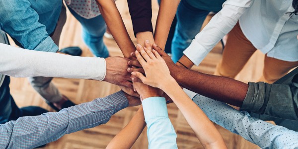 Many hands touching in a circle