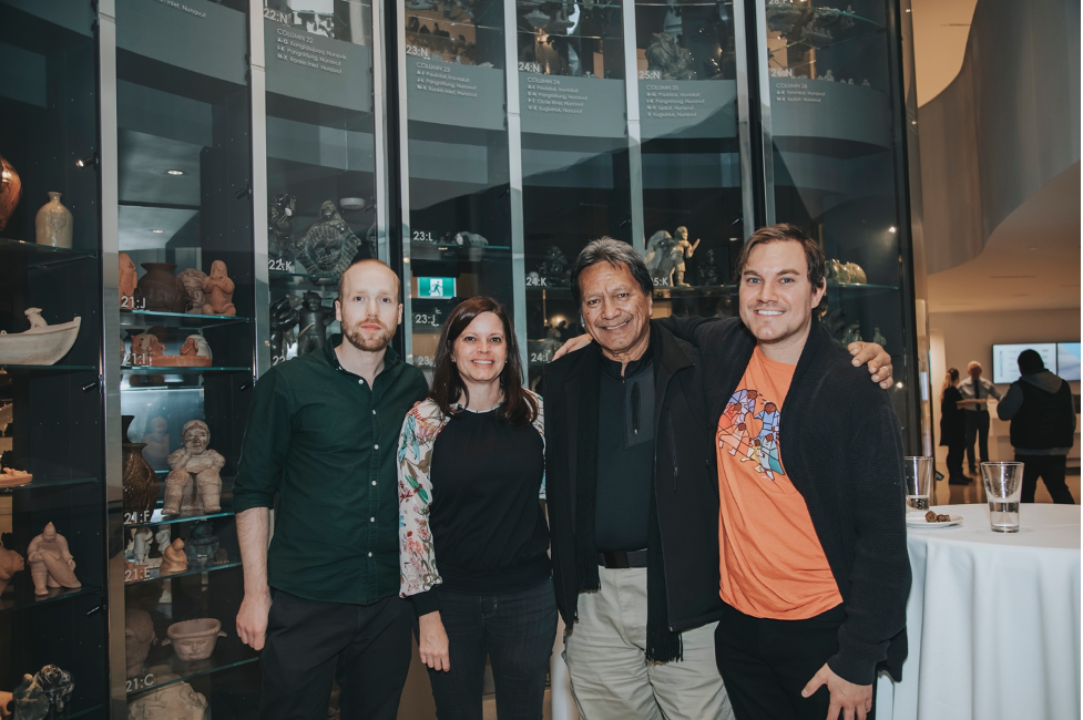 Four attendees pose for the camera