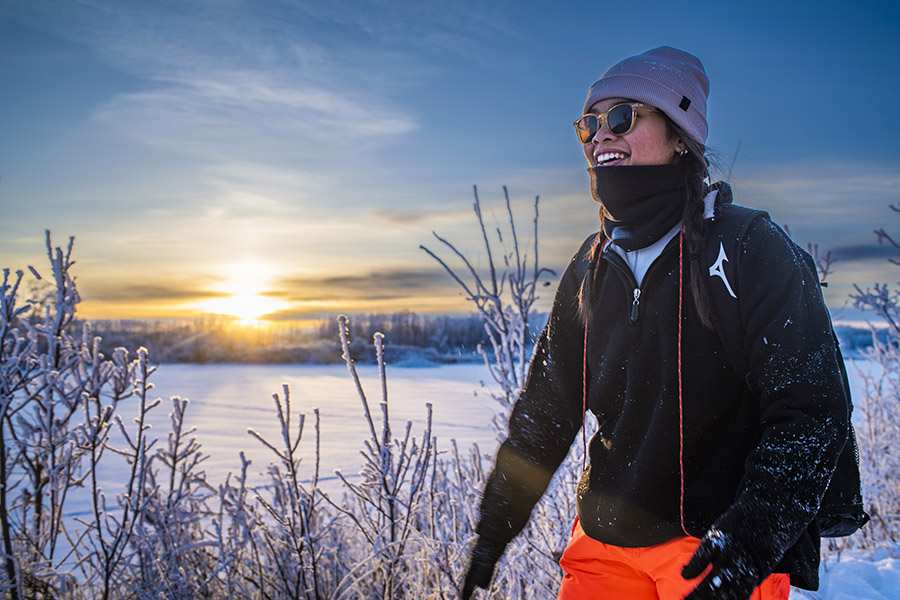 Student Gillian Ebidag walking outside in a wintery field.