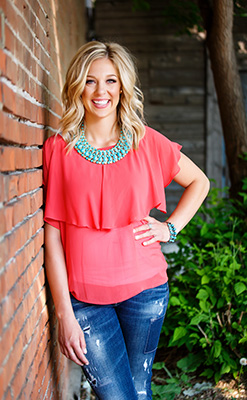 Joelle Johnson leaning against a brick wall