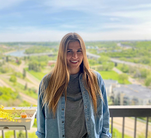 A photo of Caroline Kilmartin standing on a balcony.