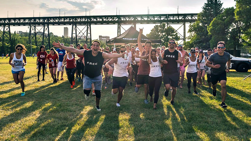 Various people outside running towards the camera in Free Fit shirts.