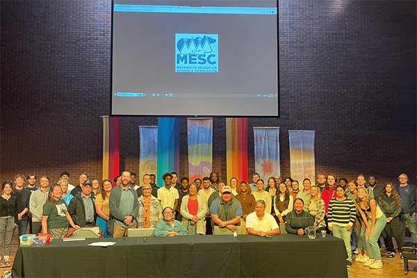 Students, faculty, staff and community members standing in the Augustana chapel to pose for a photo.