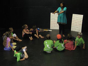 A group of children and an instructor on stage.