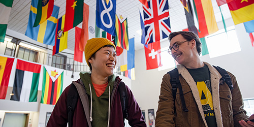 Two students standing in Augustana's Faith & Life Lounge.