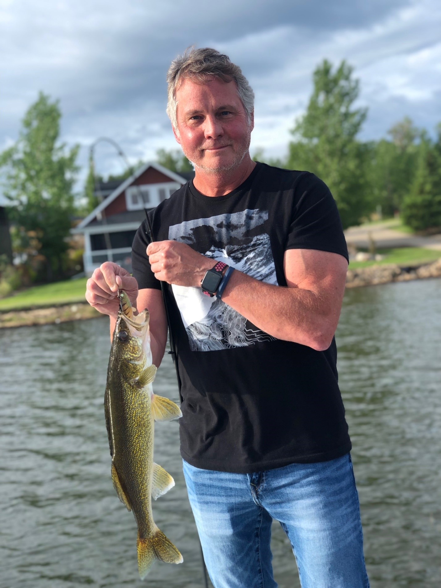 man holding a freshly caught fish