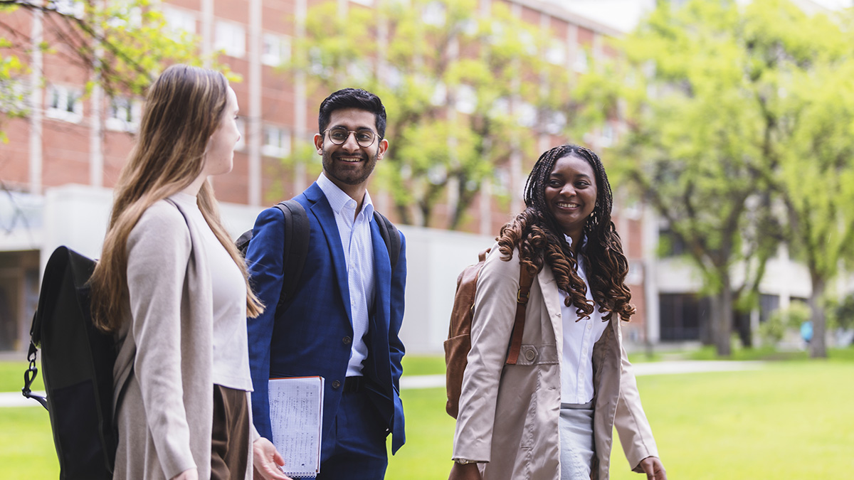 Students chatting as they walk across campus