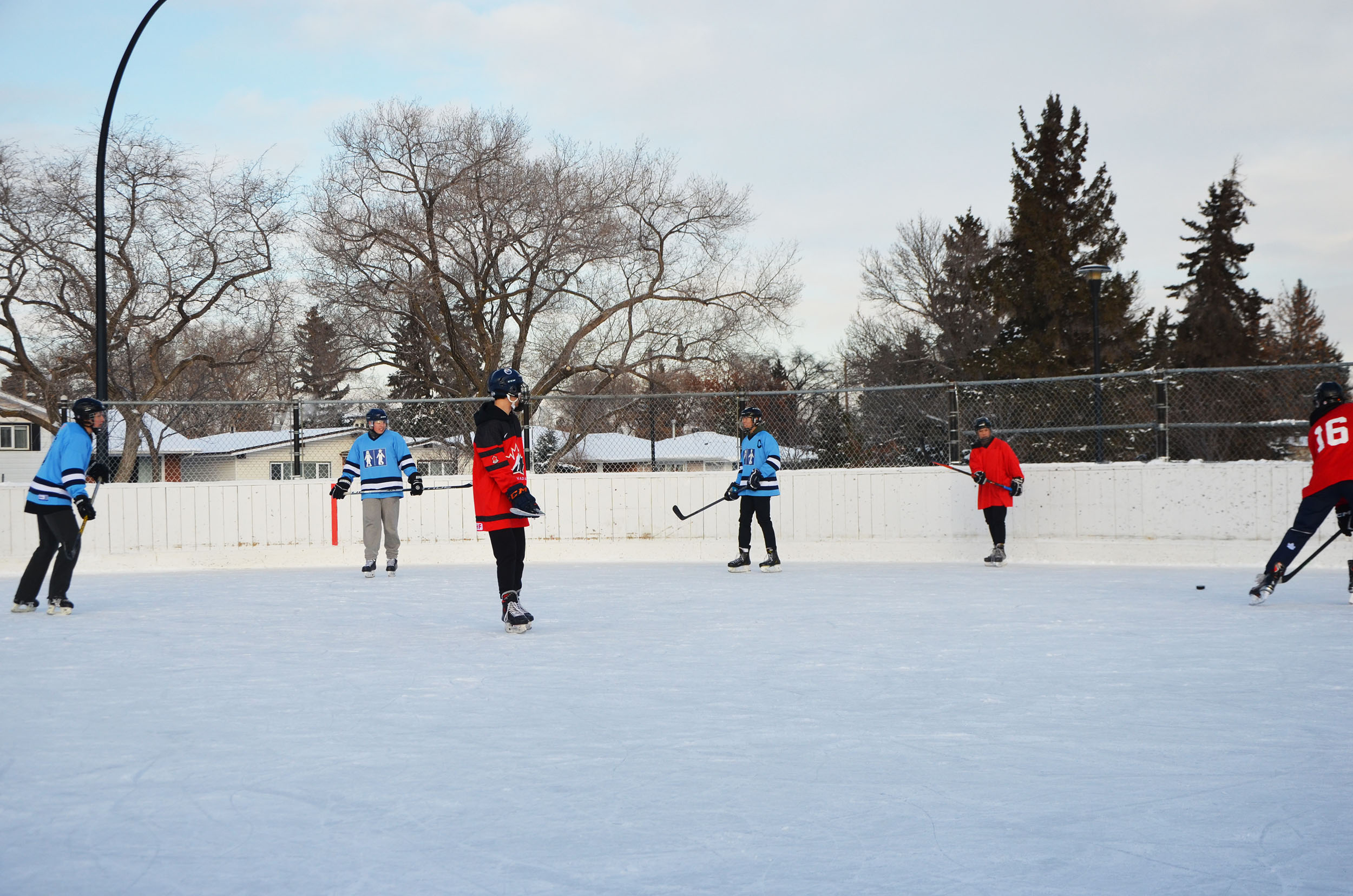 Players on ice playing pond hockey