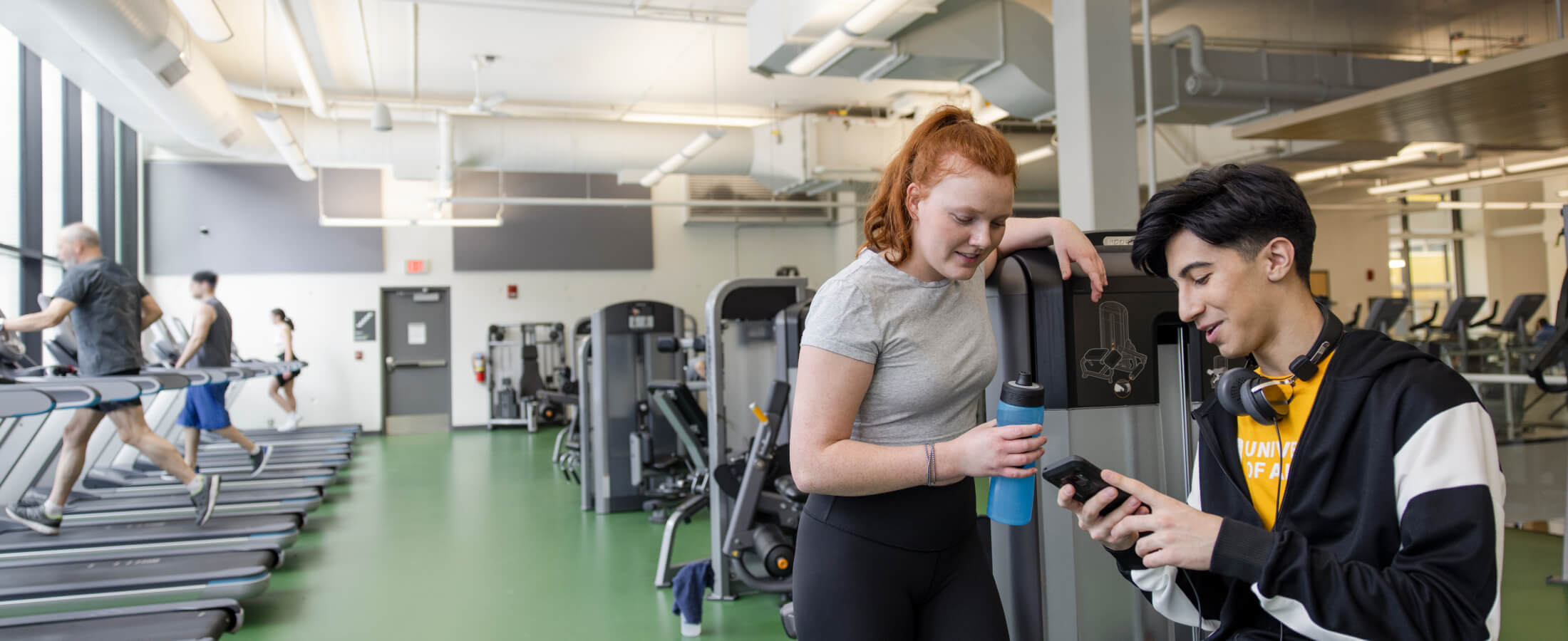 Two friends working out at gym together