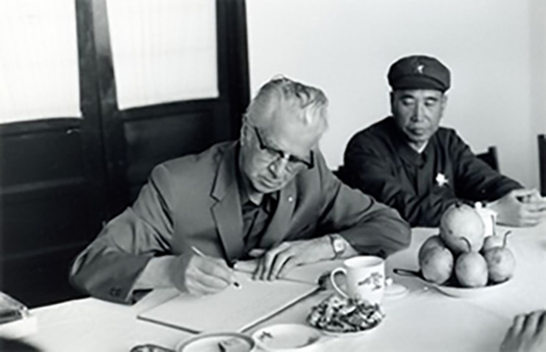 Chester Ronning signing documents