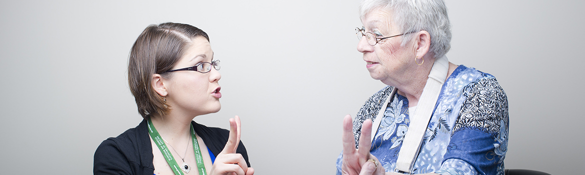 Woman speaking to another woman