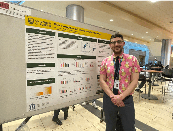 John Soleas standing beside his poster board