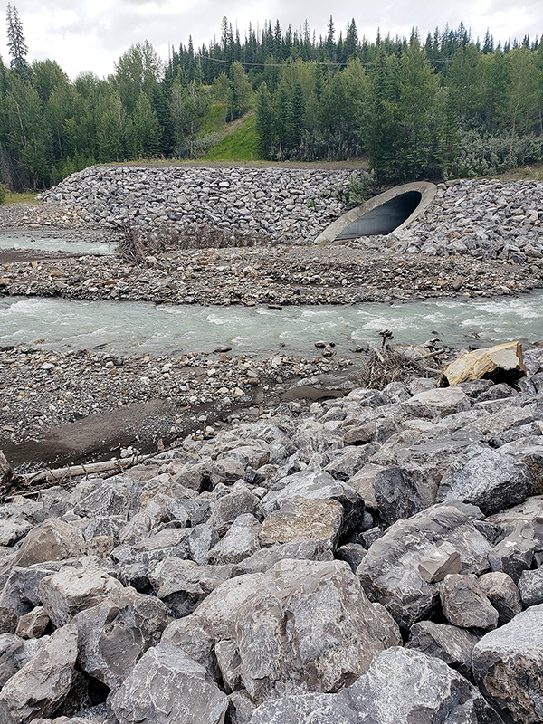 Large limestone boulders for erosion control along river bank and around culvert