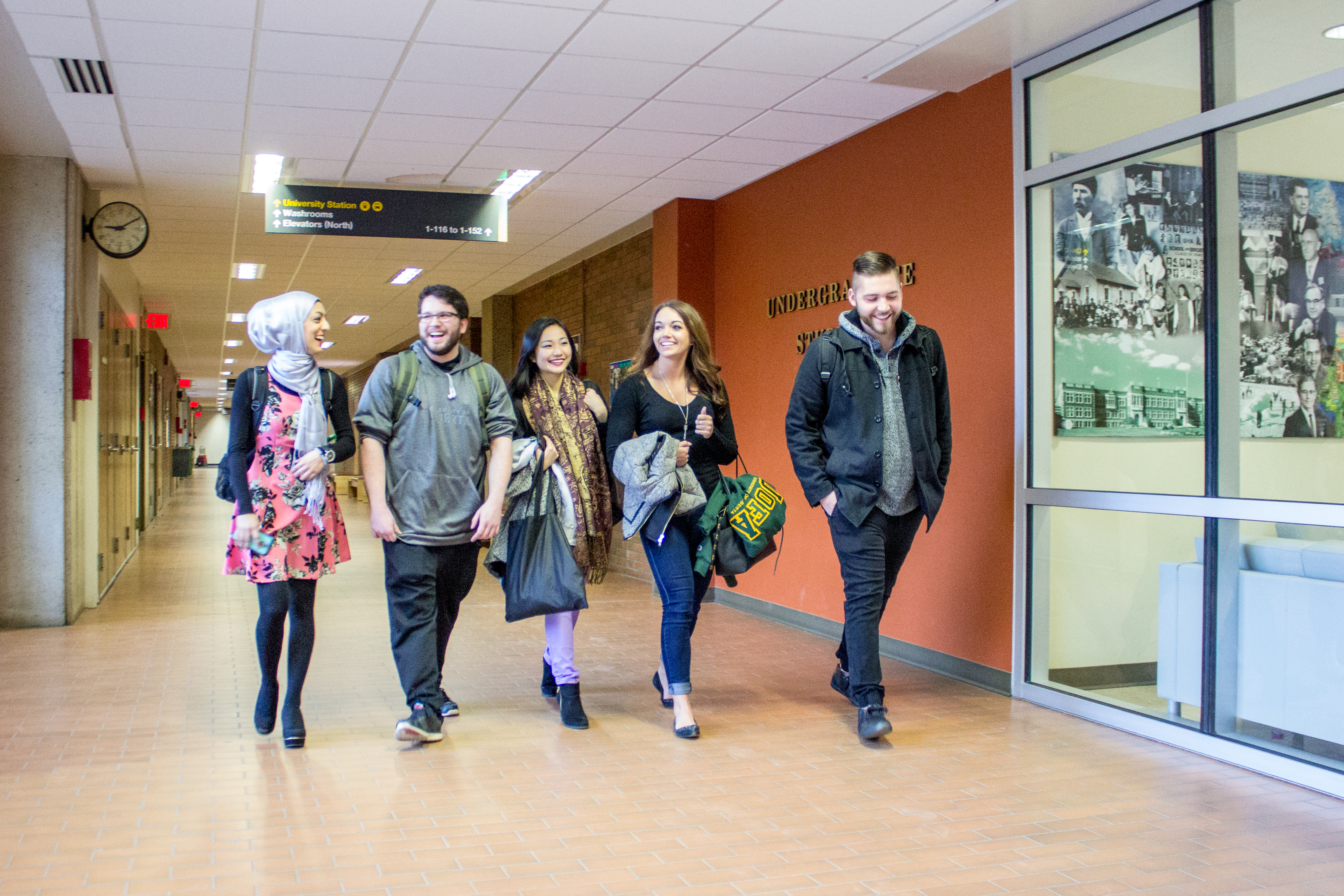 Group of students walking outside of Education Student Services office