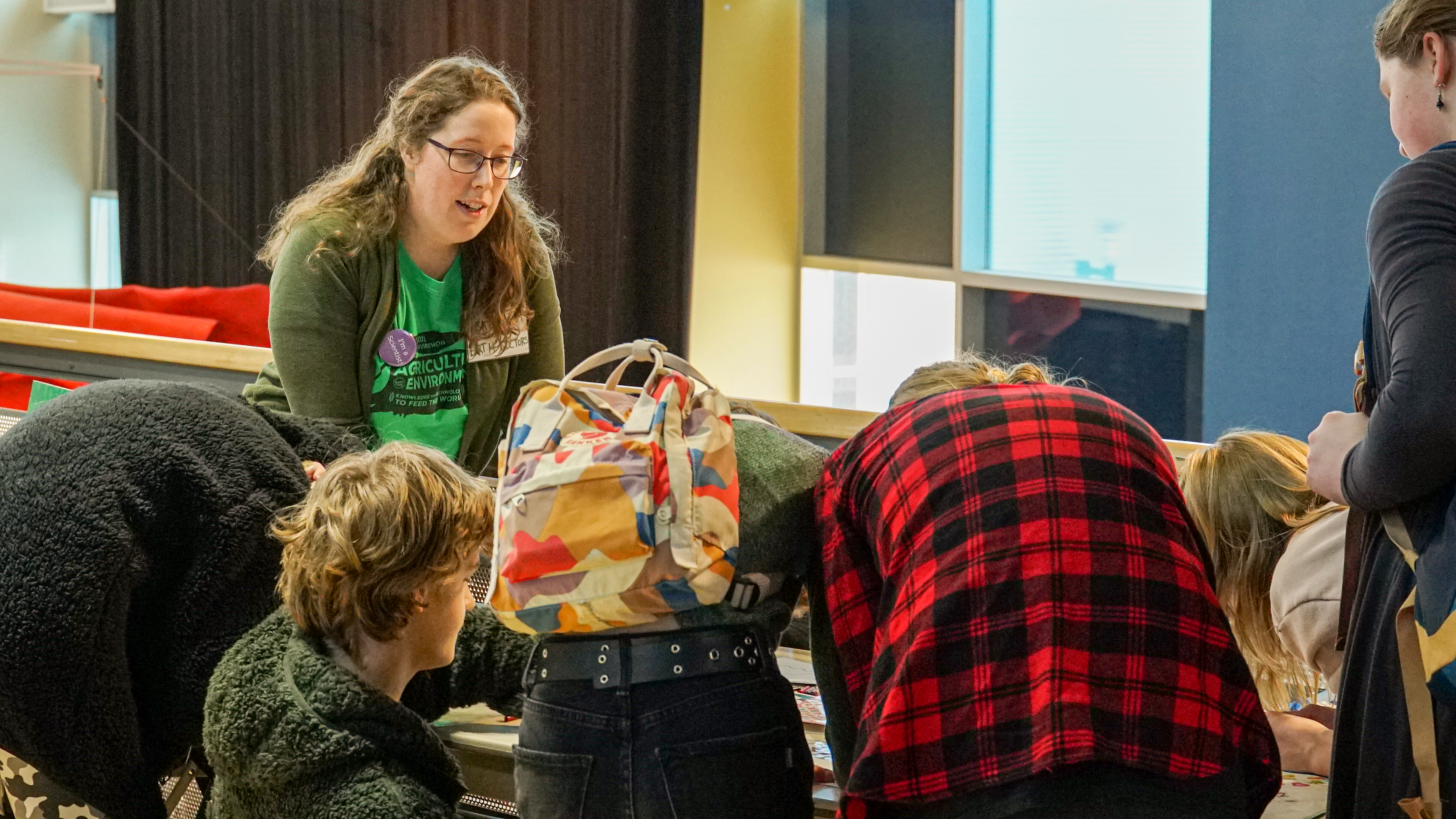 Valerie Miller teaches a group of children across a table at a science event