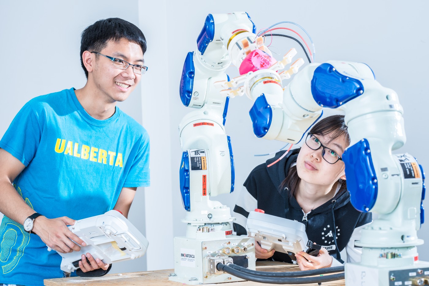 Students working with robot arms