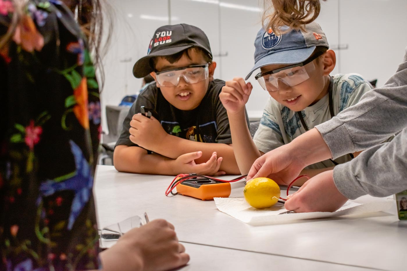 Two children working on a lemon battery