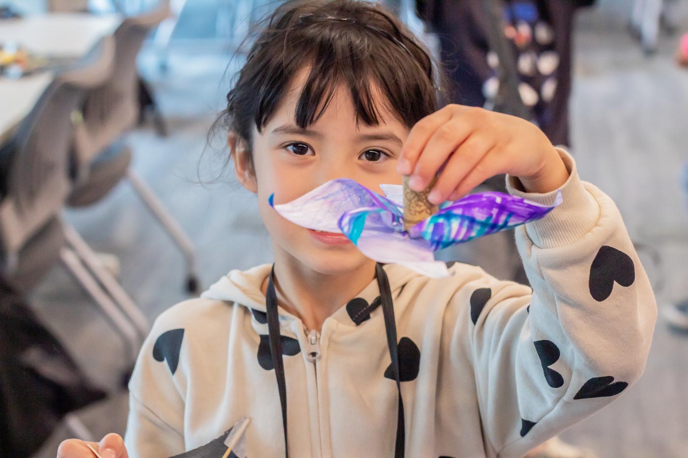 Child holding up a pinwheel