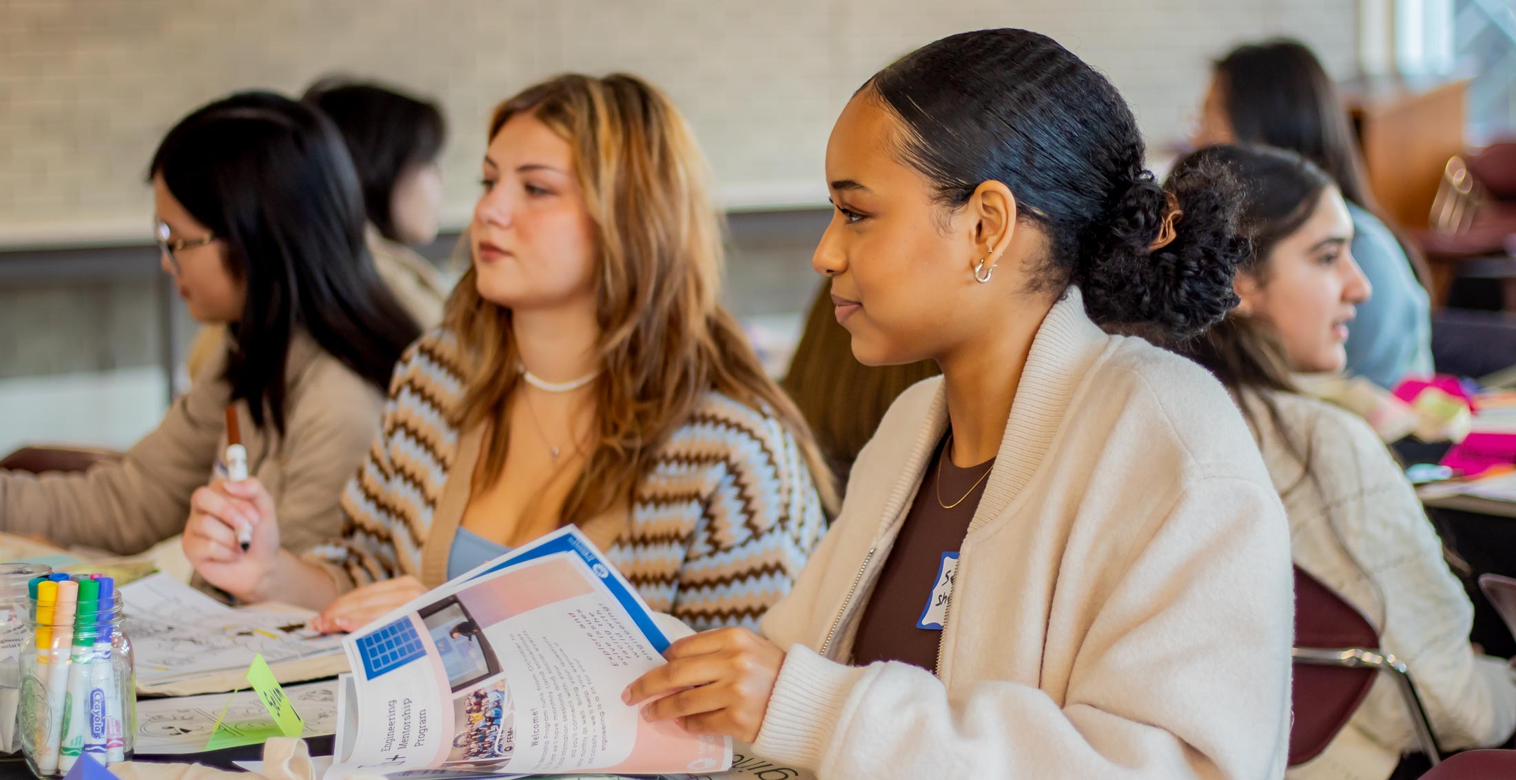 Young women in a DiscoverE FEM plus class setting