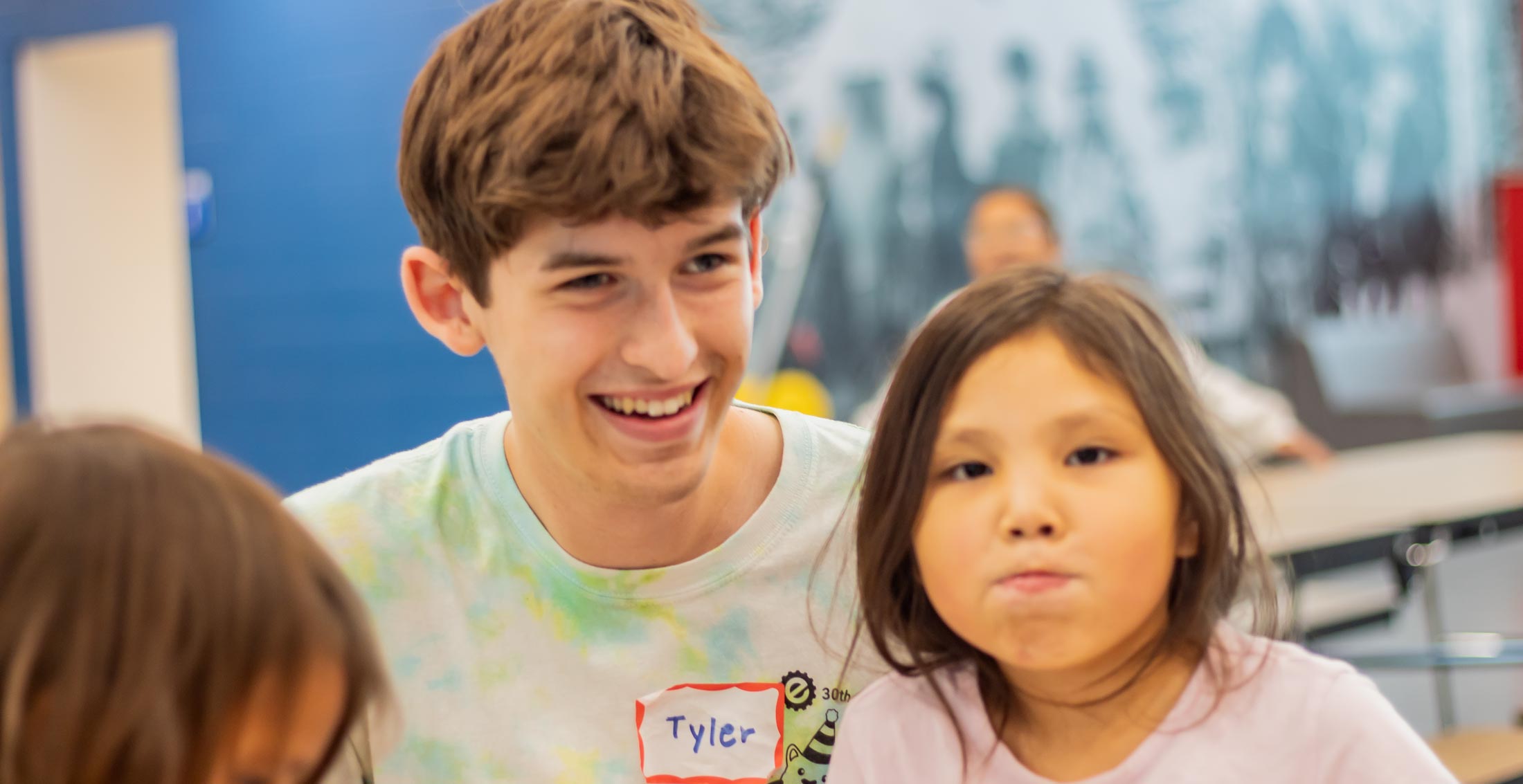 Two children in a classroom setting with their student instructor