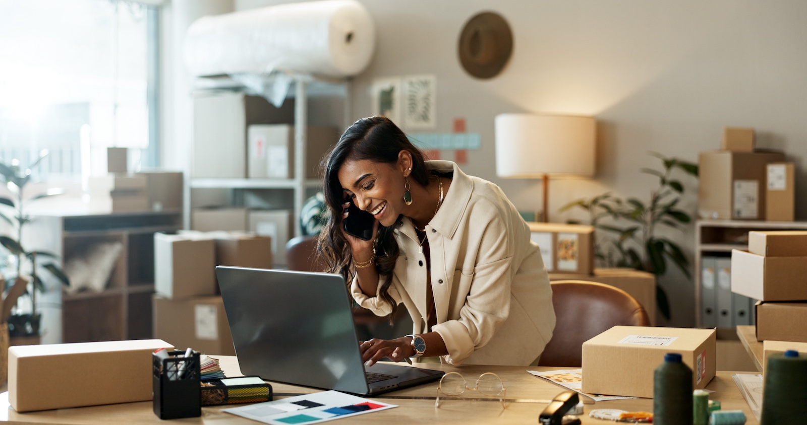 Woman on phone using laptop