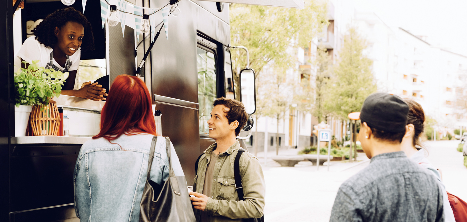 People ordering food out of the food truck