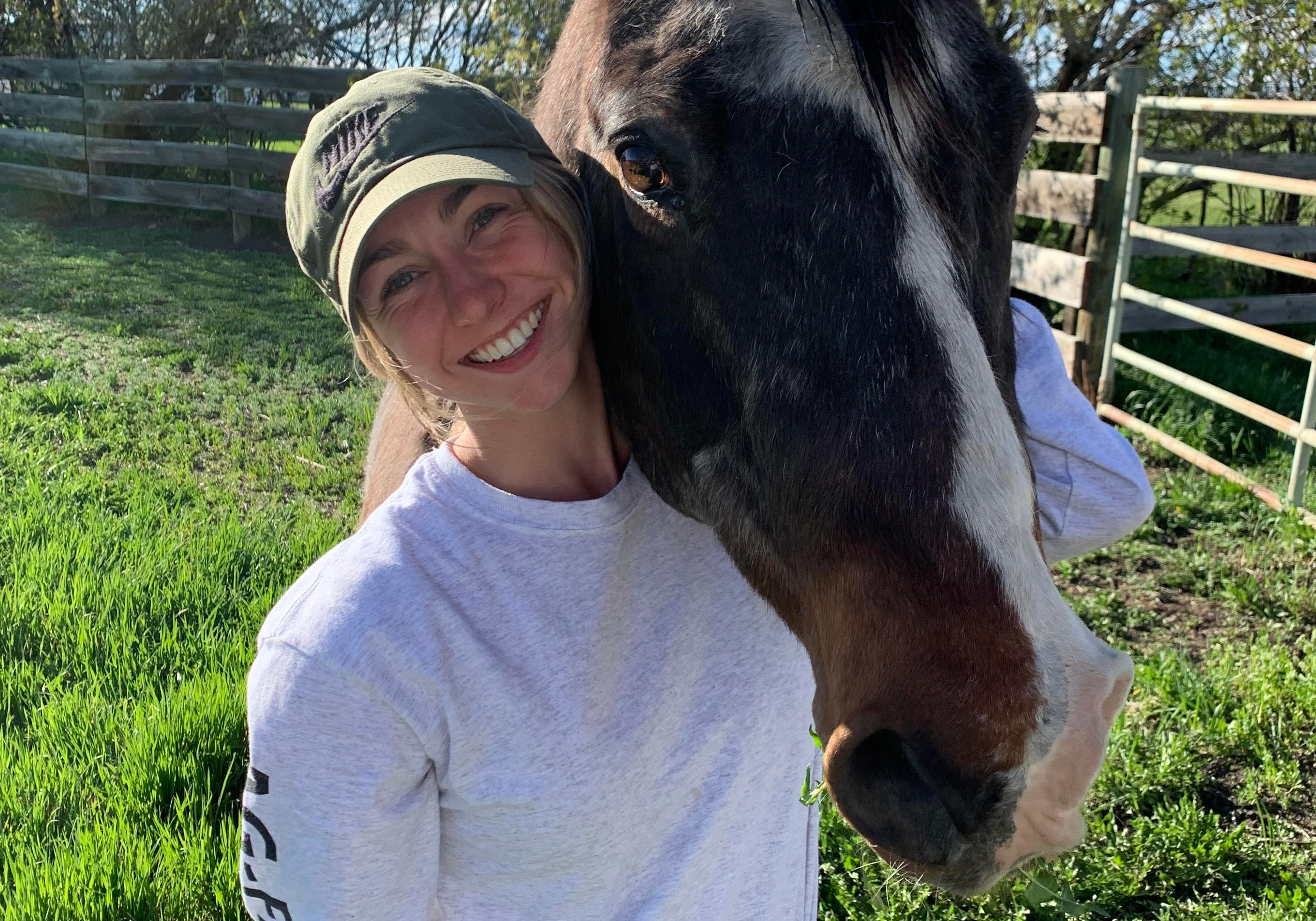 Nicole Zukiwsky on a ranch with horse