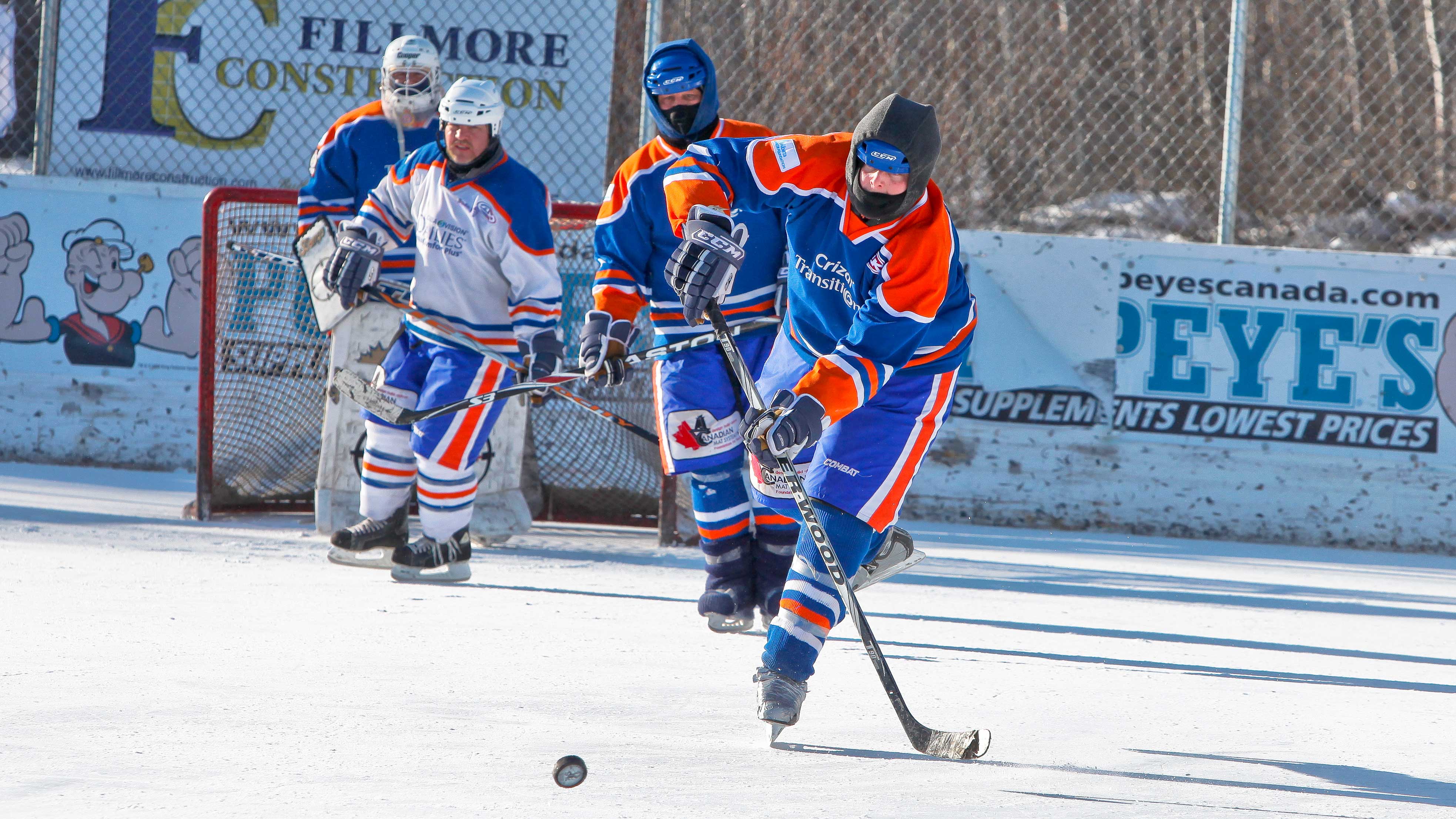 Three hockey players in the worlds longest hockey game