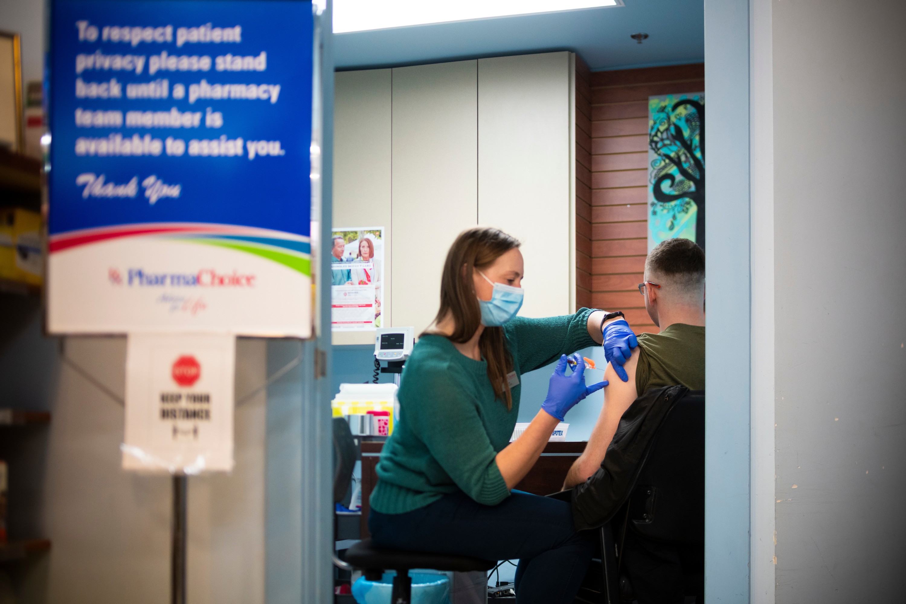 Alma Steyn administers an injection to a patient at the pharmacy she owns in Banff, Alta. (Photo: John Ulan)