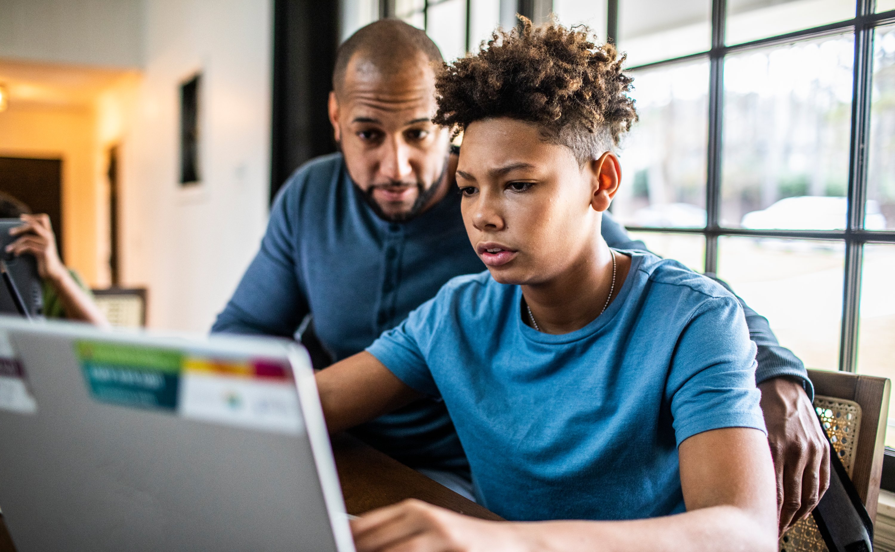 Man helps child with homework.