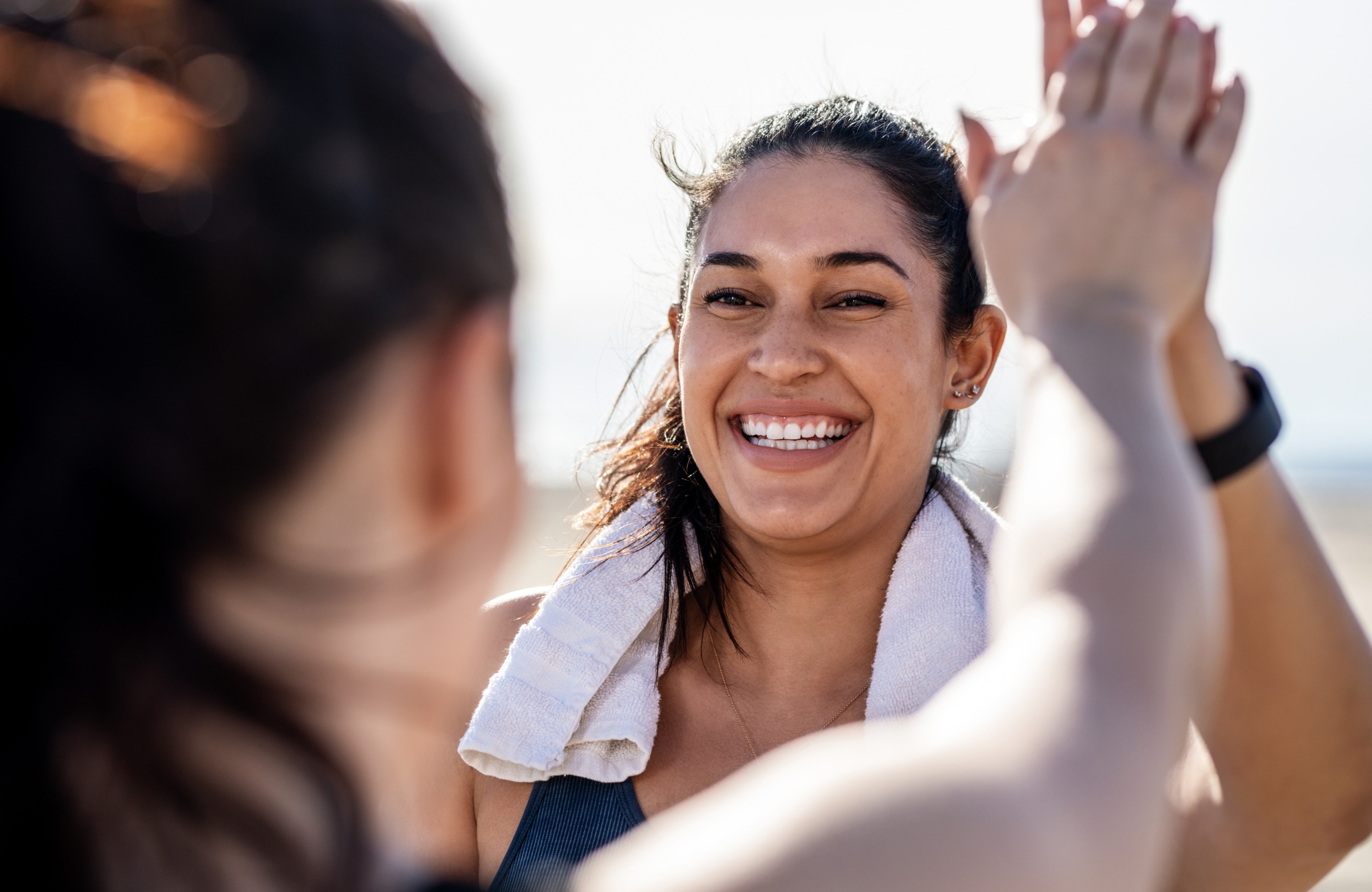 Two women high five one another after a workout. (Photo: Getty Images)