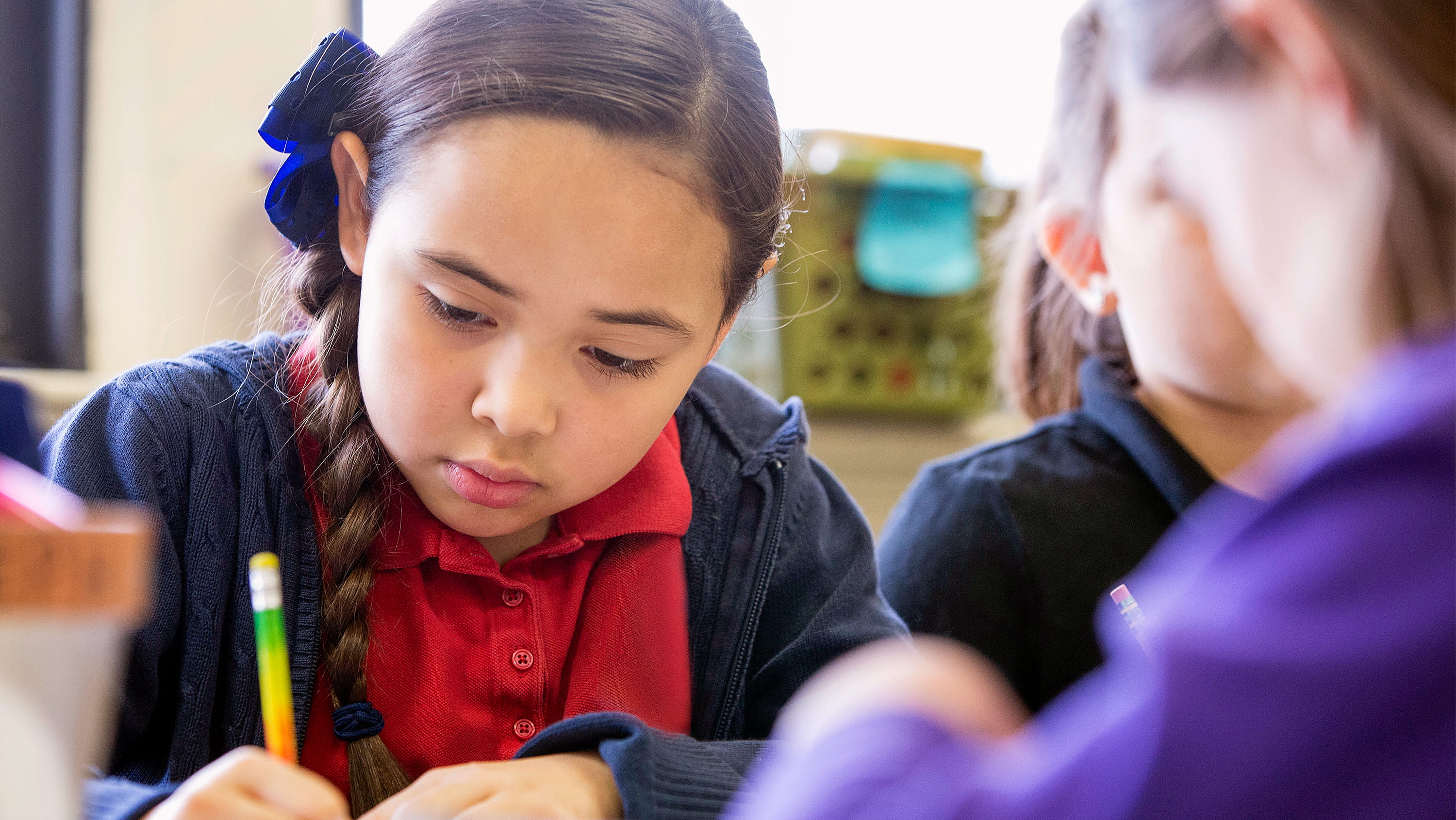 A student writing at a classroom table. (Photo: Getty Images)